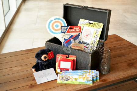 Kid in Archer - a treasure chest filled with toys for young guests