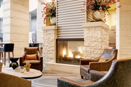 Lobby limestone fireplace with seating
