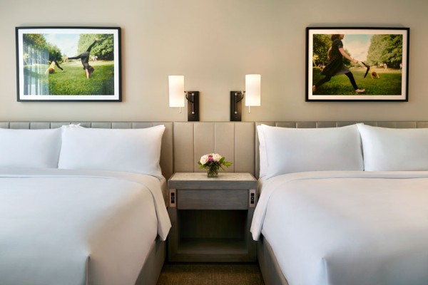 Double King beds with light fixtures and wall art
