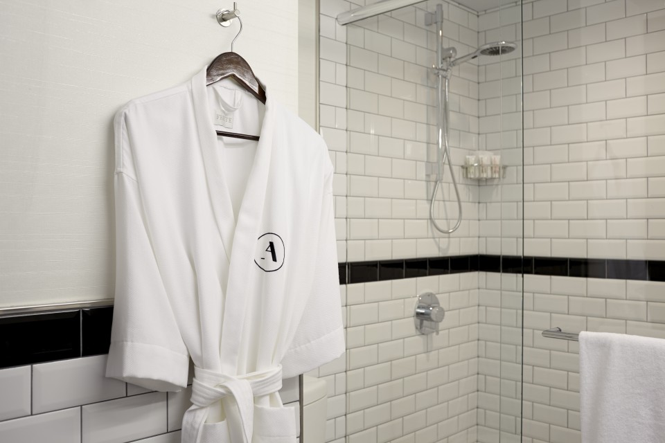 White Frette robe hanging near shower