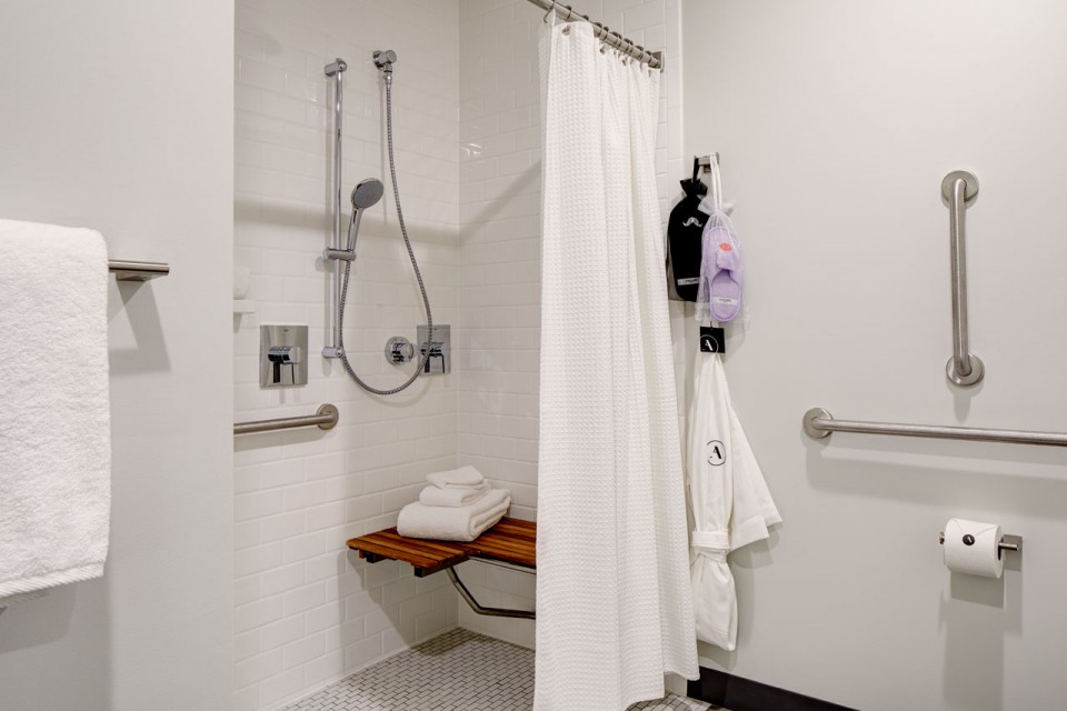 Archer's Den - mobility-accessible roll-in shower with shower seat, hand-held shower wand and grab bars