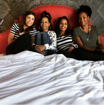 Four girls sit in Archer Guest Room